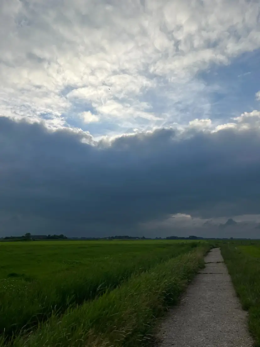 Een wandelpad door het weiland onder een wijde Groninger lucht